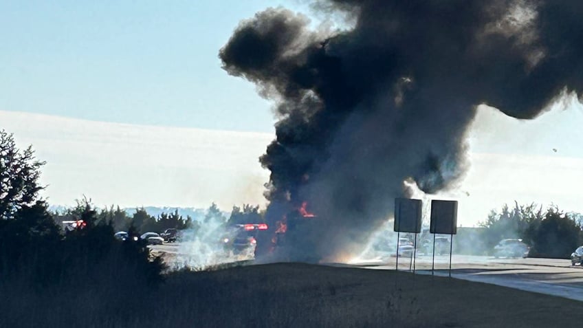 Smoke bellows from bus