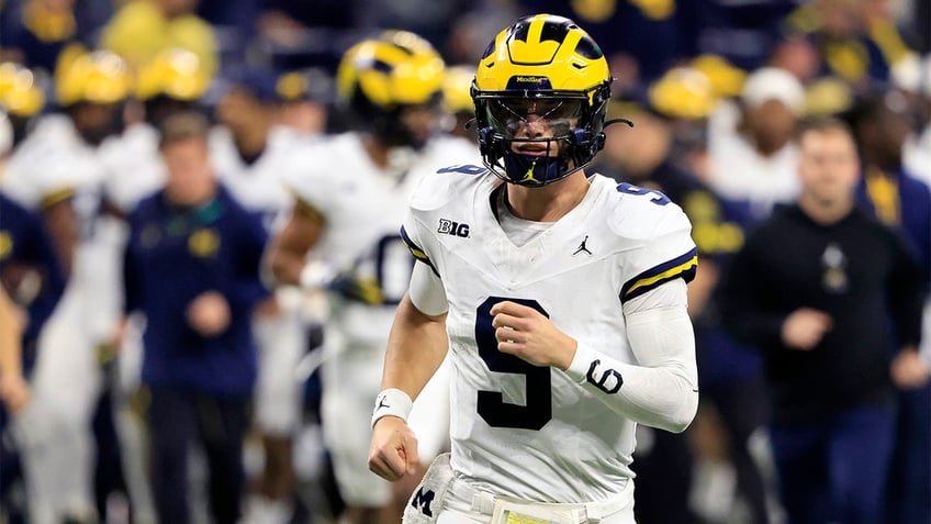 J.J. McCarthy runs onto the field