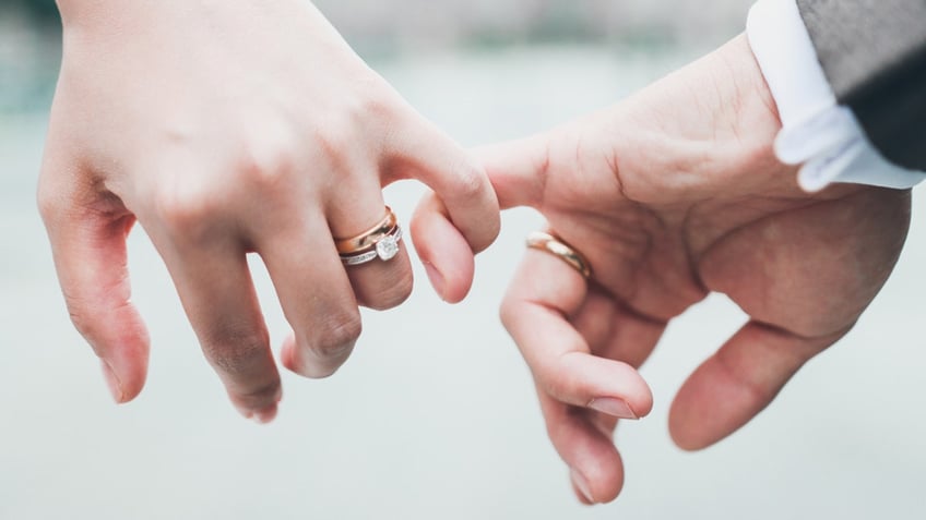 bride and groom pinky promise