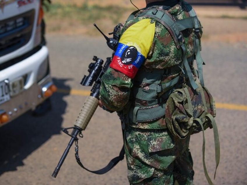 Guerrillas from the FARC-EMC enforce a roadblock in Corinto, Colombia, Friday, April 12, 2