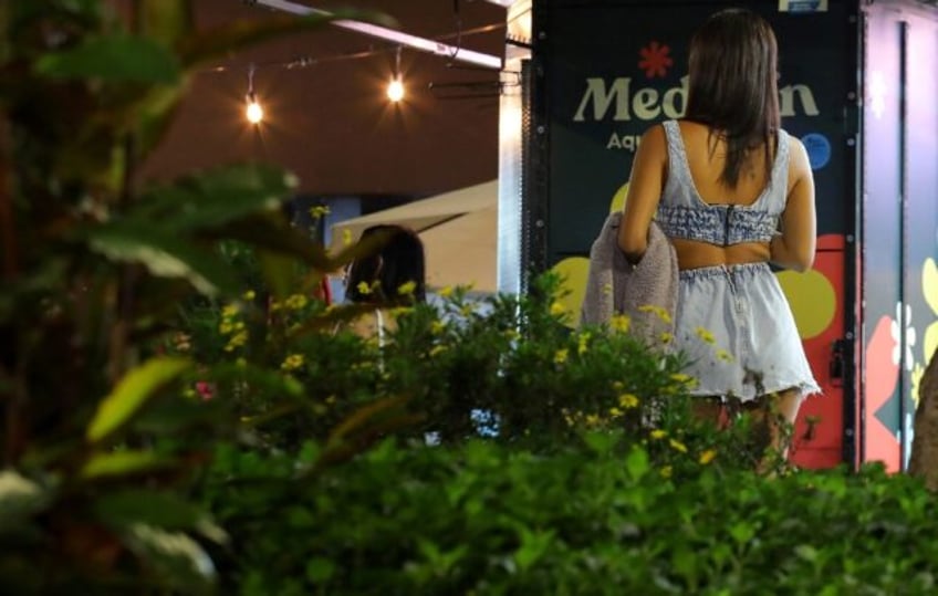 A woman walks in Lleras park in Medellin -- the city expects a record number of visitors t