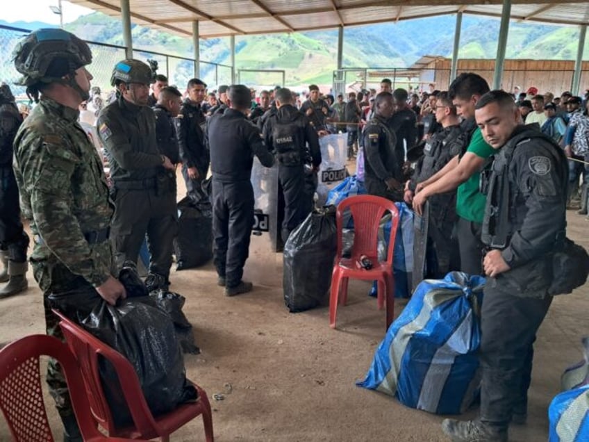 Security personnel taken captive by dissident members of the FARC rebel group wait for the