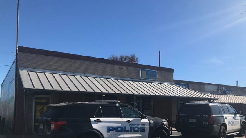 Two Commerce City police vehicles parked outside a business