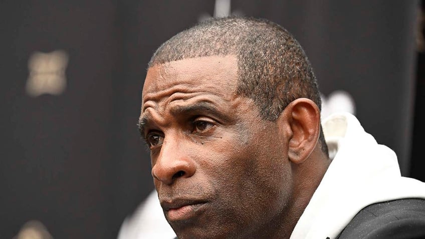 Deion Sanders speaks at a press conference