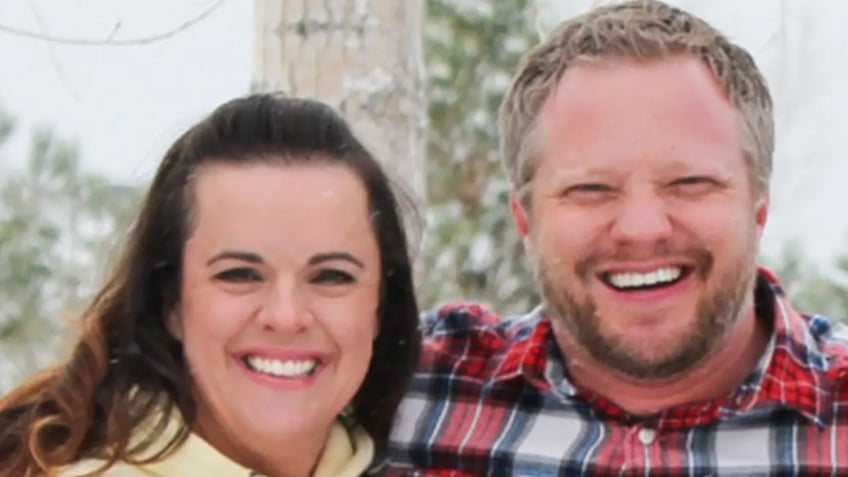 Angela and James Craig smiling in a family portrait.