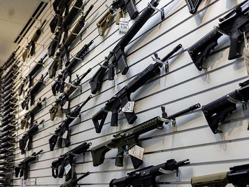 A selection of AR-15-style rifles hangs on a wall at R-Guns store on Jan. 11, 2023, in Car