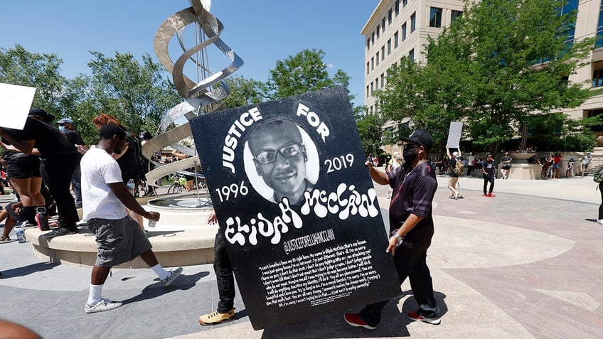 Demonstrators hold a rally following McCain's death