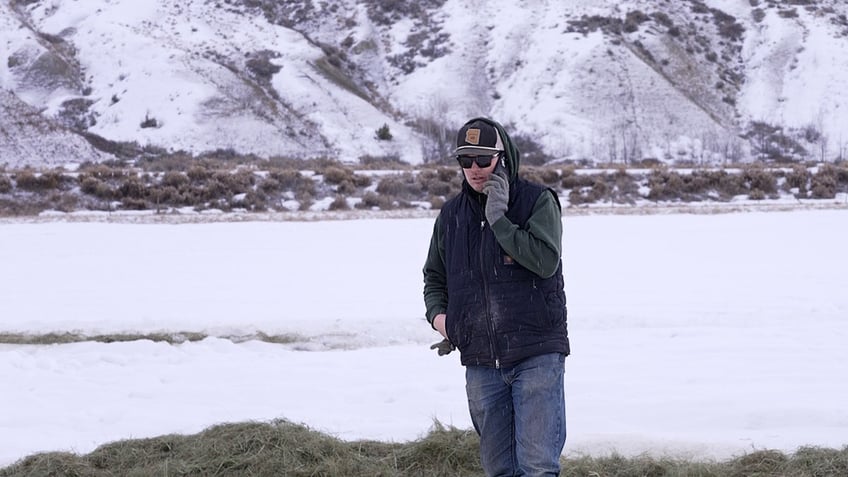 tim ritschard on the phone in snowy field