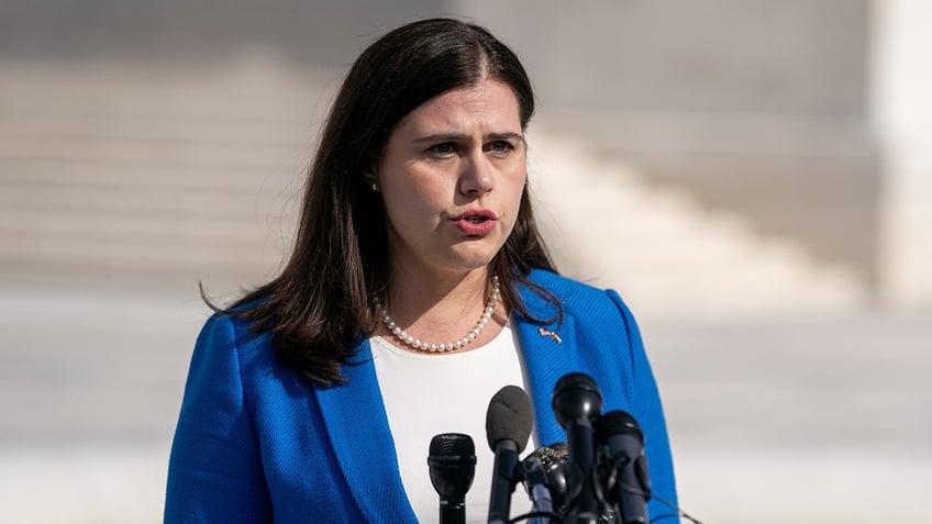 Colorado Secretary of State Jena Griswold speaks into microphones