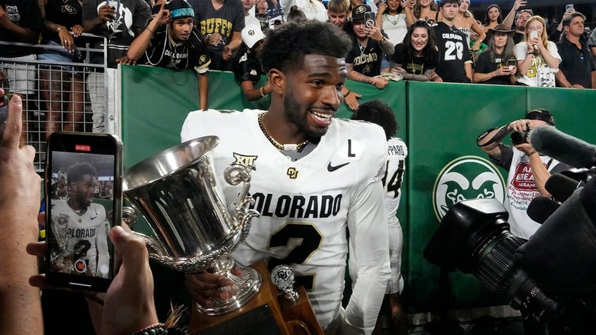 Shedeur Sanders holds trophy