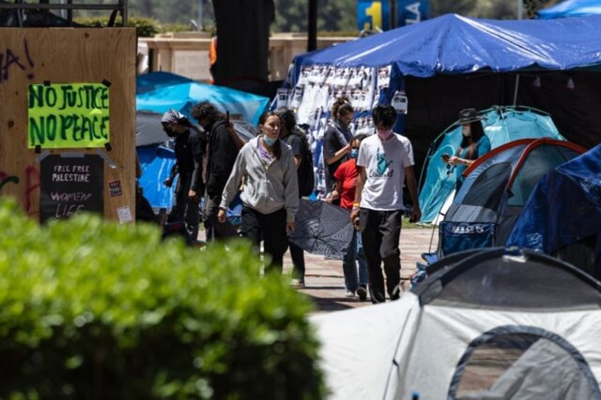 People walk inside a pro-Palestinian protest encampment on the campus of the University of