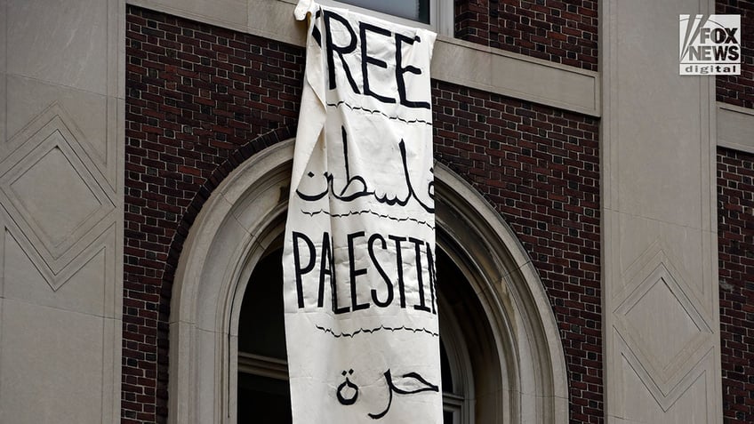 Anti-Israel protesters hang signs from Columbia University in New York City