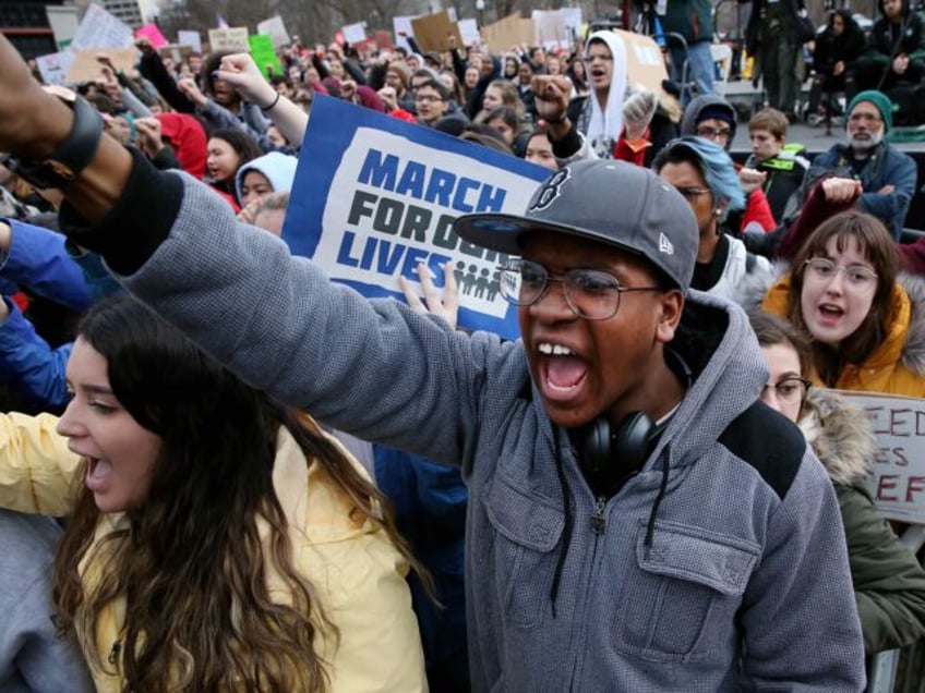 Boston, MA - March 24: Khymani James, 14, chants with the crowd during the March for Our L