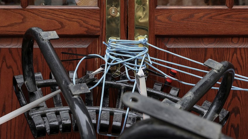 Outdoor furniture and ropes secure the front entrance of Hamilton Hall at Columbia University