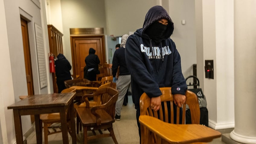 Protesters carrying chairs