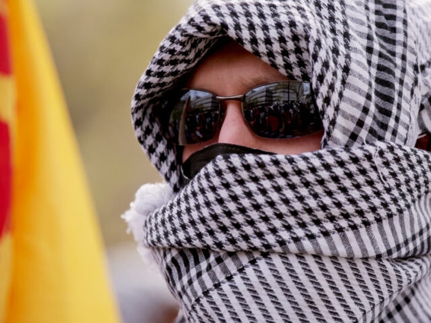 Pro-Palestinian protesters wear keffiyehs as they march from City College to Columbia Univ