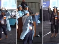 Columbia University student in handcuffs rips up diploma on commencement stage in act of protest