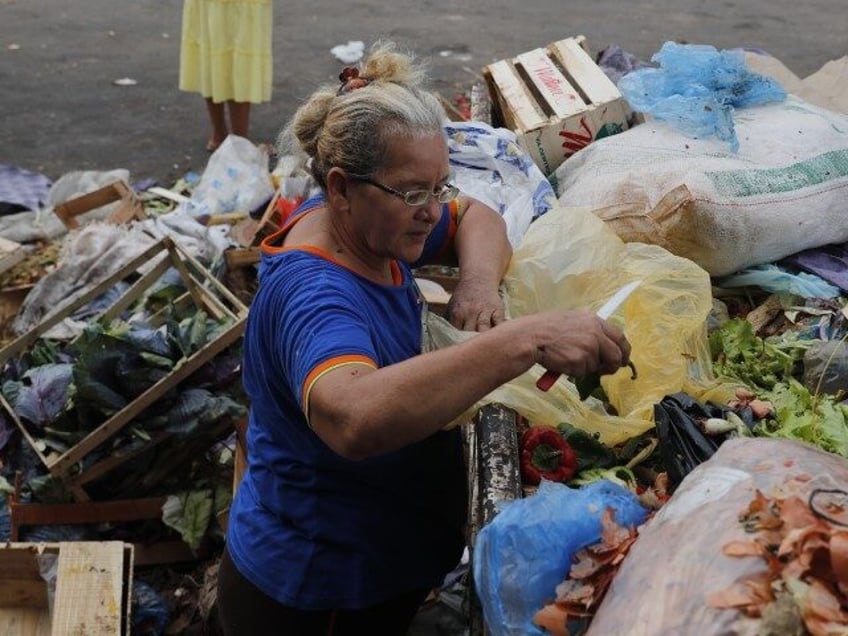 Leticia Kuhn, a 57-year-old mother of eight and grandmother of 20, scavenges for food to t