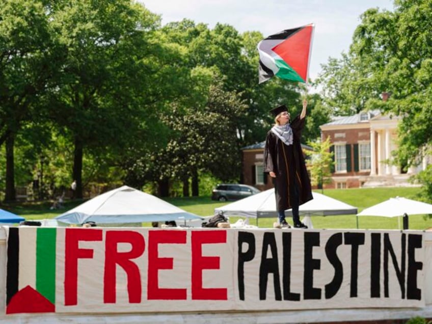 Jonah Smith, a graduating Johns Hopkins University senior, waves a Palestinian flag in his