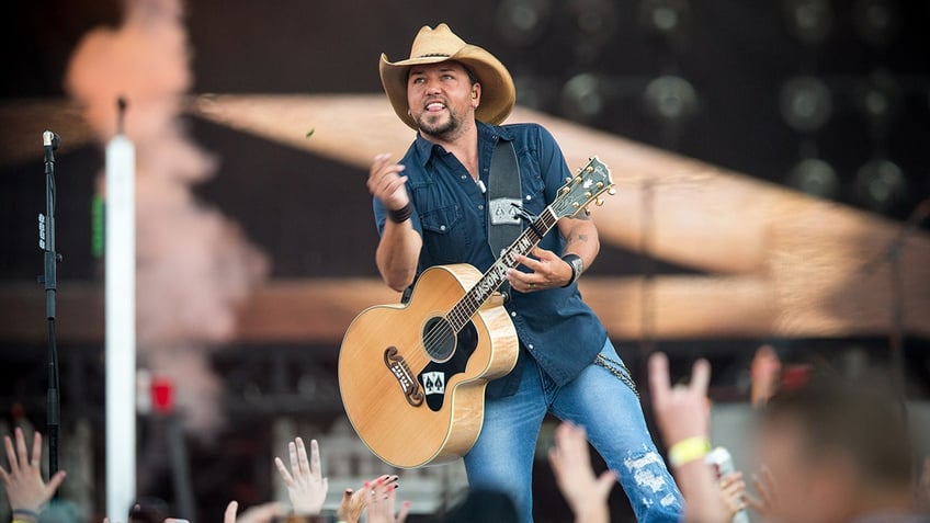 communist revolutionaries burn american flags outside jason aldean concert claiming america was never great