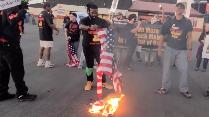 communist revolutionaries burn american flags outside jason aldean concert claiming america was never great