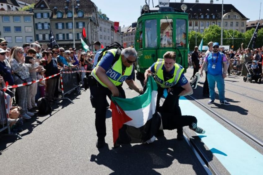 Police officers tackled a protester holding a Palestinian flag during the Eurovision Song
