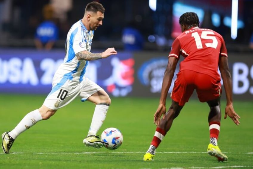 Argentina's Lionel Messi dribbles past Canada player Moise Bombito in Thursday's Copa Amer