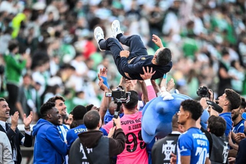 Porto's players toss coach Sergio Conceicao in the air after winning the Portuguese Cup in