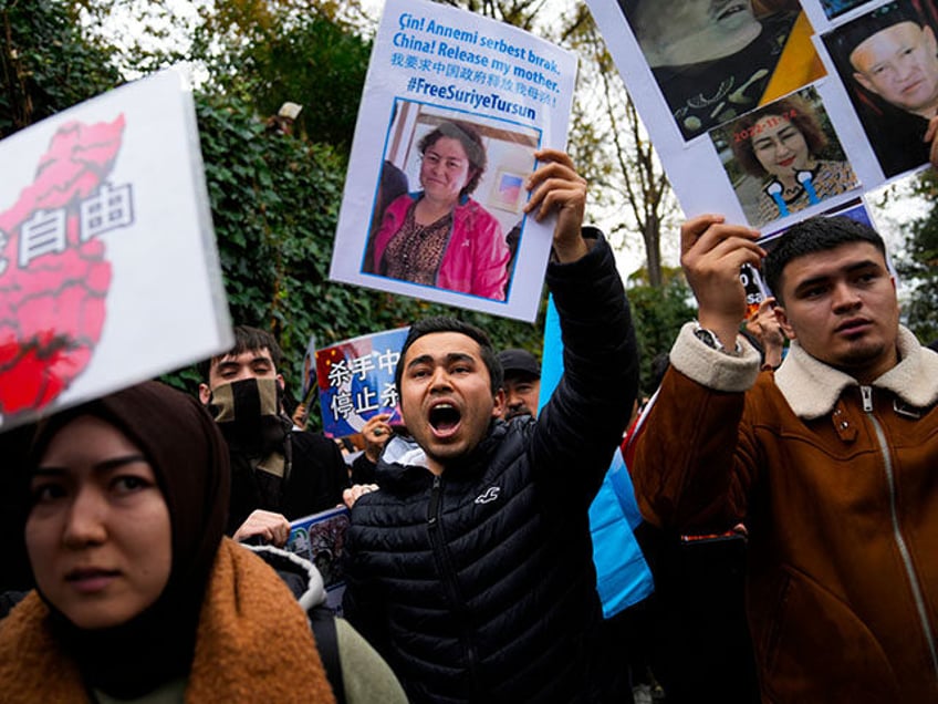 Protesters chant slogans as they hold posters and pictures of victims during a protest aga