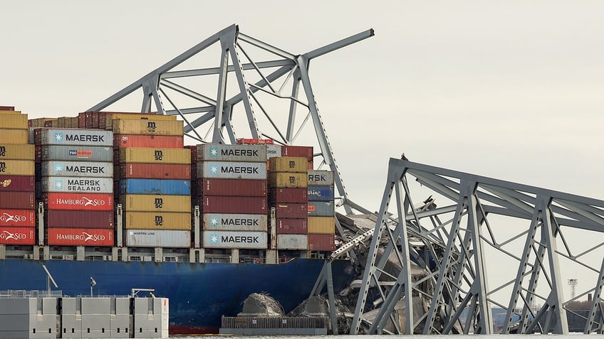 The cargo ship Dali sits in the water after running into and collapsing the Francis Scott Key Bridge