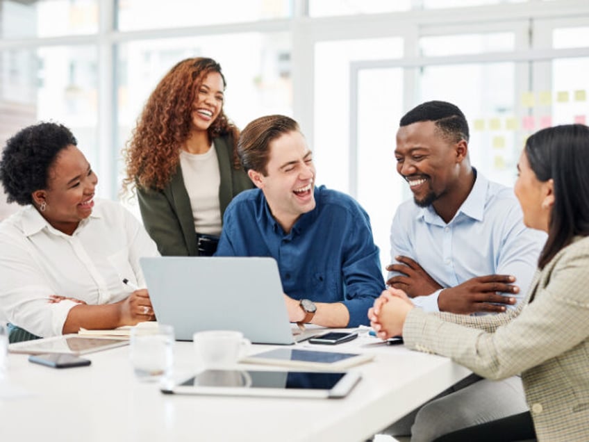 Happy businesspeople have a discussion in an office.