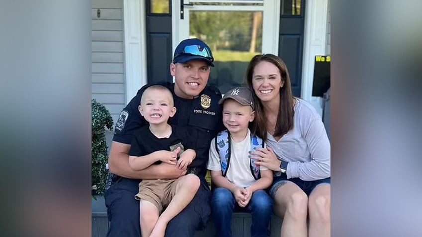 Trooper First Class Aaron Pelletier, his wife, Dominique and their two sons.