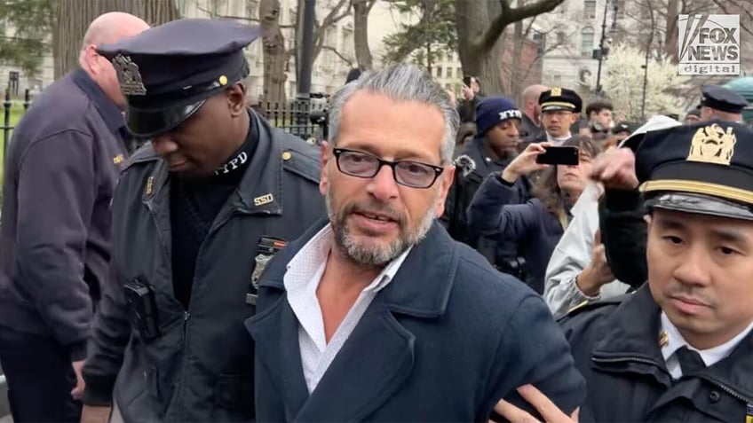 conservative artist handcuffed during pizza tossing protest outside new york city hall