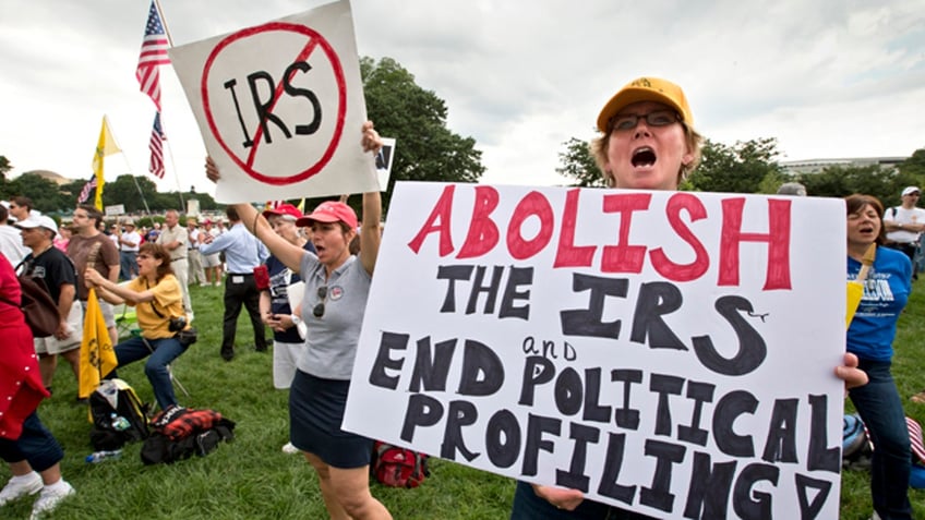 Tea party activists attend a rally on the grounds of the U.S. Capitol in Washington, Wednesday, June 19, 2013. The IRS has been under fire from Democrats and Republicans in Congress since May, when one of its officials publicly apologized for targeting conservative groups' applications for tax-exempt status for close examination. (AP Photo/J. Scott Applewhite)