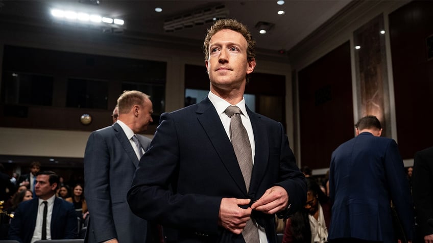 Mark Zuckerberg, chief executive officer of Meta Platforms Inc., center, arrives following a break during a Senate Judiciary Committee hearing in Washington, D.C., on Wednesday, Jan. 31, 2024.