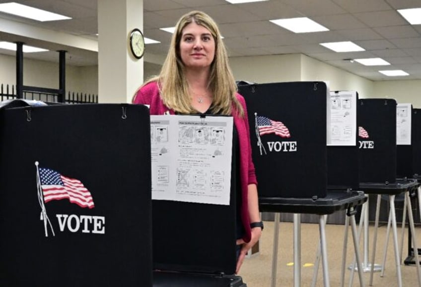 Joanna Francescut, the election registrar in California's Shasta County, stands in a voti