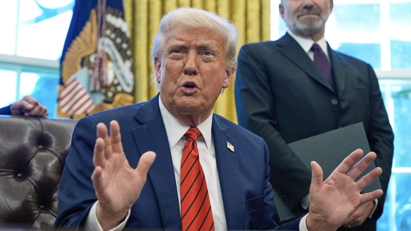 Trump puts up hands at Oval Office desk