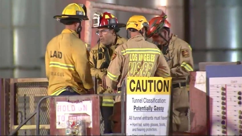This image taken from footage provided by KABC/ABC7 Los Angeles shows first responders working the scene after a tunnel collapsed on Wednesday, July 9, 2025, in Los Angeles.