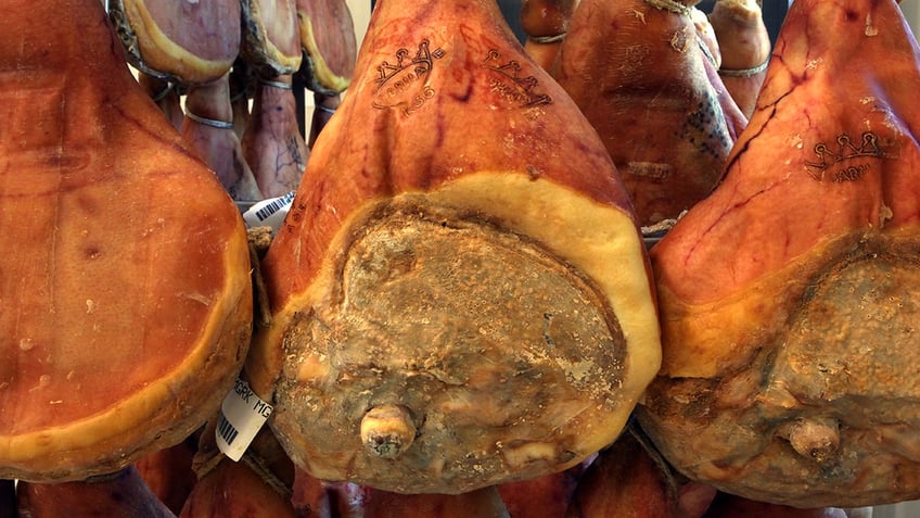 Prosciutto hanging to cure