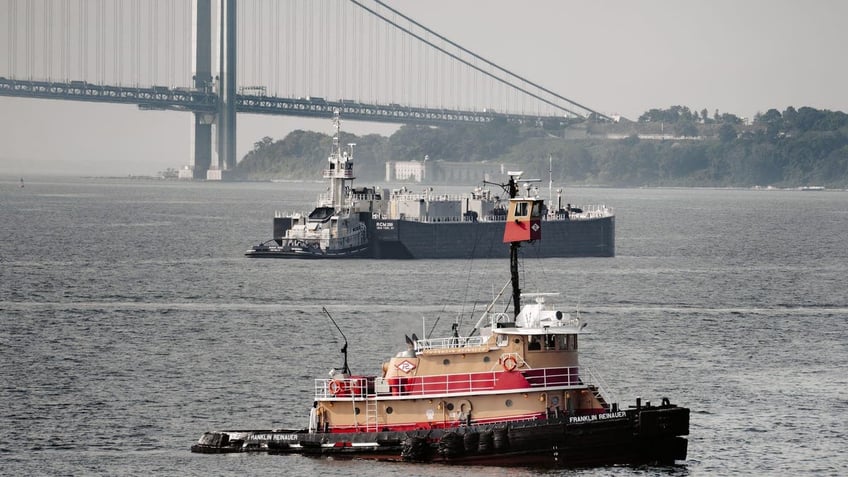 Tugboat and barge in upper New York Bay with Verrazzano-Narrows Bridge and Staten Island in background< New York City, New York, USA