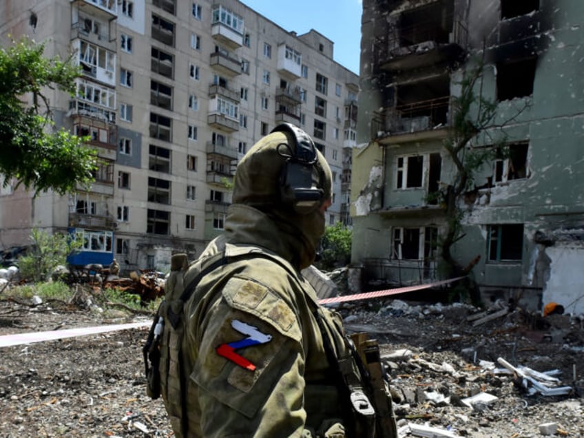 TOPSHOT - A Russian serviceman patrols a destroyed residential area in the city of Severodonetsk on July 12, 2022, amid the ongoing Russian military action in Ukraine. (Photo by Olga MALTSEVA / AFP) (Photo by OLGA MALTSEVA/AFP via Getty Images)