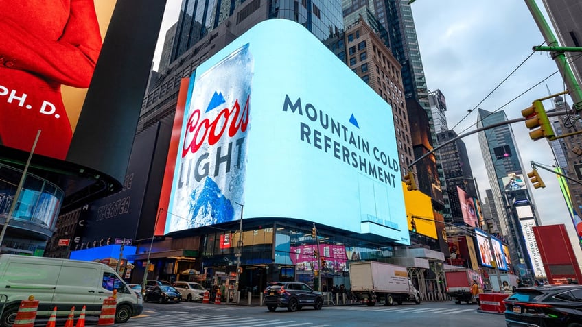 A billboard in New York City's Times Square displays the Coors Light advertisement with the misspelled slogan: "Mountain Cold Refershment."