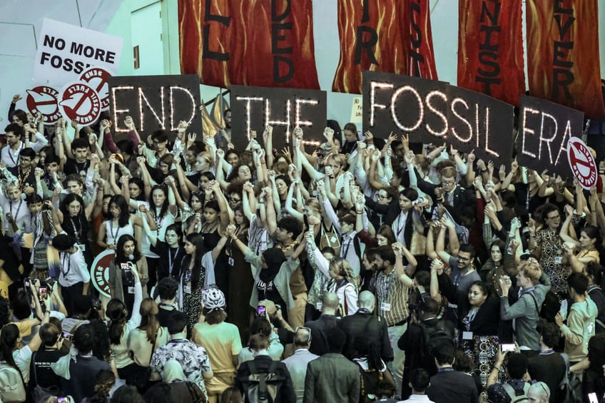 cop28 delegates clap cheer each other as beginning of the end for fossil fuels declared