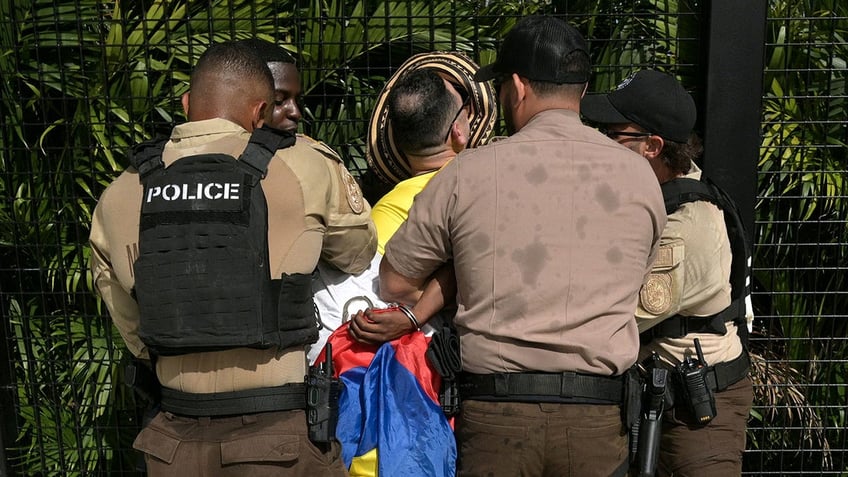 Officers detain a fan