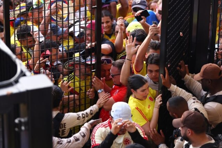 Fans are caught in a crush during chaotic scenes before the Copa America final on Sunday w