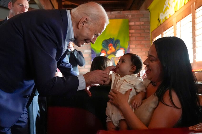 couldnt resist biden awkwardly wanders off stage to pull faces with a baby