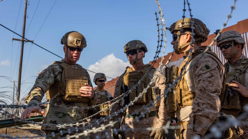 Soldiers observe razor wire used at the southern border in California 