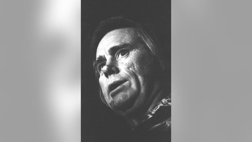 A close-up of George Jones on stage.