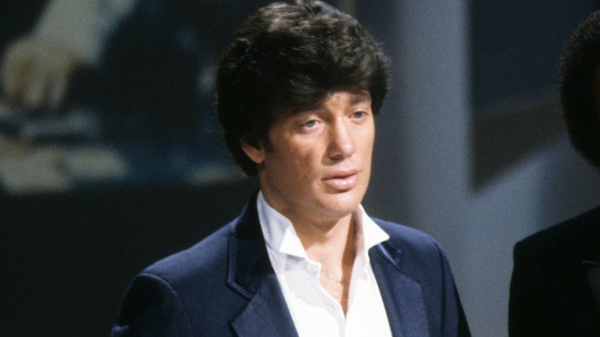 Ronnie McDowell wears a suit on TV