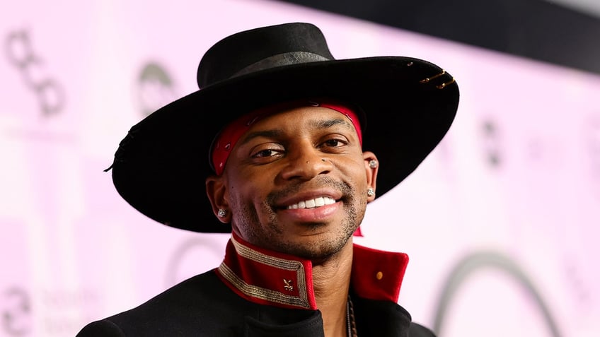 Jimmie Allen wearing a hat